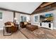 Living room with rustic wood detail on vaulted ceiling and large windows at 1392 W Caley Ave, Littleton, CO 80120