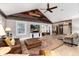 Open concept living room with hardwood floors, ceiling fan, rustic wood features at 1392 W Caley Ave, Littleton, CO 80120