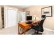 Office with desk, office chair, beige carpet and artwork at 1392 W Caley Ave, Littleton, CO 80120