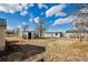 Spacious backyard with multiple outbuildings, providing endless possibilities for storage, hobbies, or creating your dream outdoor oasis at 13581 Sable Blvd, Brighton, CO 80601