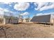 Backyard view with a shed and solar panels under a cloudy sky at 13581 Sable Blvd, Brighton, CO 80601