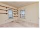 Neutral bedroom featuring carpeted floors and two windows with built-in shelving at 13581 Sable Blvd, Brighton, CO 80601