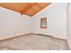 Bright bedroom featuring vaulted wood ceiling, carpeted floors, and a single window at 13581 Sable Blvd, Brighton, CO 80601