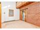 Bedroom with brick wall and access to deck at 13581 Sable Blvd, Brighton, CO 80601