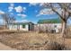 Charming home exterior showcasing a green roof and well-maintained facade, offering a delightful glimpse of this property's character at 13581 Sable Blvd, Brighton, CO 80601