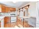 Traditional style kitchen featuring white appliances, wood cabinets, and dining bar at 13581 Sable Blvd, Brighton, CO 80601