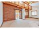 Open living area with vaulted ceiling and brick feature wall at 13581 Sable Blvd, Brighton, CO 80601