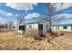 This white outbuilding boasts a green roof, offering rustic charm and potential for various uses on this expansive property at 13581 Sable Blvd, Brighton, CO 80601