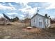 View of shed featuring a light gray exterior, green trim, and a small patio at 13581 Sable Blvd, Brighton, CO 80601