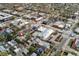 Wide aerial view of a neighborhood featuring residences, commercial buildings, and tree-lined streets at 34 W Maple Ave, Denver, CO 80223