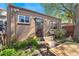 Private backyard featuring a patio area, lush landscaping, mature trees, and outdoor seating at 34 W Maple Ave, Denver, CO 80223