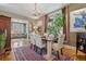 Bright dining room with hardwood floors, large windows, stylish furnishings, and an open view to living room at 34 W Maple Ave, Denver, CO 80223