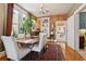 Inviting dining room features exposed brick, hardwood floors, and built-in shelving at 34 W Maple Ave, Denver, CO 80223