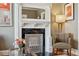 Close-up of an elegant living room fireplace with decorative mantle, marble surround, and stylish decor at 34 W Maple Ave, Denver, CO 80223
