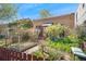 Inviting home showcasing a lush front yard with garden beds and charming curb appeal at 34 W Maple Ave, Denver, CO 80223