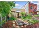 View of the home's exterior showcasing a garden, walkway, and lush landscaping at 34 W Maple Ave, Denver, CO 80223