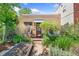 Charming home featuring a well-maintained front yard with garden beds and a cozy entrance at 34 W Maple Ave, Denver, CO 80223