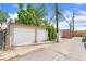 Two-car garage with a paved alleyway, showcasing the convenience and accessibility of parking at 34 W Maple Ave, Denver, CO 80223