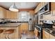 Updated kitchen featuring stainless steel appliances and tile floors at 34 W Maple Ave, Denver, CO 80223