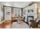 Inviting living room featuring hardwood floors, a decorative fireplace, a comfortable sofa and lots of natural light at 34 W Maple Ave, Denver, CO 80223