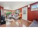 Well-lit living room with hardwood floors, comfortable seating, and large windows offering backyard views at 34 W Maple Ave, Denver, CO 80223