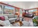 Comfortable living room with hardwood floors, cozy seating, decorative pillows and ample natural light at 34 W Maple Ave, Denver, CO 80223