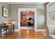 Open doorway leading to a home office/music room with desk, computer, musical instruments, and bright accents at 34 W Maple Ave, Denver, CO 80223