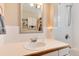 Bathroom featuring a white vanity, mirror, and tile walls at 2754 S Sherman St, Englewood, CO 80113