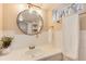 Bright bathroom with a large round mirror, towel rack and some decor at 2754 S Sherman St, Englewood, CO 80113
