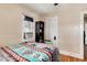 Bedroom featuring hardwood floors, neutral paint, and an air conditioning unit at 2754 S Sherman St, Englewood, CO 80113