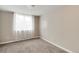 Sunlit bedroom with neutral paint and carpet, featuring a large window at 2754 S Sherman St, Englewood, CO 80113