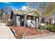 Charming two-story home with a well-manicured yard featuring mature trees, a concrete driveway, and a welcoming covered porch at 2754 S Sherman St, Englewood, CO 80113