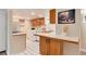 Charming kitchen with breakfast bar, white appliances, and decorative touches at 2754 S Sherman St, Englewood, CO 80113