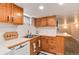 Efficient kitchen features wood cabinets, stainless steel sink, and tile backsplash at 2754 S Sherman St, Englewood, CO 80113
