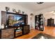 Open-concept living room with hardwood floors, an entertainment center, and easy access to other living spaces at 2754 S Sherman St, Englewood, CO 80113