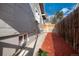 Narrow side yard with colorful mulch and a pathway leading to the backyard at 2754 S Sherman St, Englewood, CO 80113