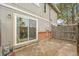 Backyard patio featuring sliding glass door, brick foundation and privacy fence at 1344 Sable Blvd, Aurora, CO 80011