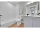 Bathroom featuring a vanity, mirror, bathtub, and toilet at 1344 Sable Blvd, Aurora, CO 80011