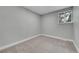 Empty bedroom features neutral paint, plush carpet, and a window at 1344 Sable Blvd, Aurora, CO 80011