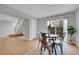 Open floor plan with dining area leading to stairs and a bright living area at 1344 Sable Blvd, Aurora, CO 80011