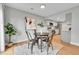 Bright dining area with modern table and chairs adjacent to the kitchen with stainless steel appliances at 1344 Sable Blvd, Aurora, CO 80011