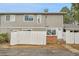 Neutral townhouse with white fencing, offering a quaint curb appeal at 1344 Sable Blvd, Aurora, CO 80011
