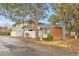 Exterior view of a brick and siding townhome with mature trees and community signage on the property at 1344 Sable Blvd, Aurora, CO 80011