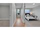 Hallway with wood floors, leading to a carpeted bedroom with natural light at 1344 Sable Blvd, Aurora, CO 80011