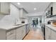 Modern eat-in kitchen with stainless steel appliances and grey cabinets at 1344 Sable Blvd, Aurora, CO 80011