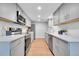 Modern kitchen with stainless steel appliances, white subway tile backsplash, and gray cabinetry at 1344 Sable Blvd, Aurora, CO 80011