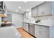 Bright kitchen featuring stainless steel appliances, white countertops, and updated cabinetry at 1344 Sable Blvd, Aurora, CO 80011