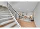 Bright living room with modern decor, hardwood floors, and a staircase at 1344 Sable Blvd, Aurora, CO 80011