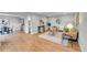 Open-concept living area with hardwood floors, and access to the kitchen at 1344 Sable Blvd, Aurora, CO 80011