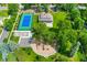 An aerial view of neighborhood park with a tennis court, playground, and open space at 6901 E 12Th Ave, Denver, CO 80220